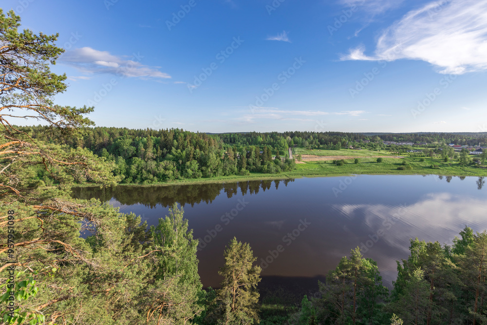 A lake with a forest in the background A lake with a forest in the background