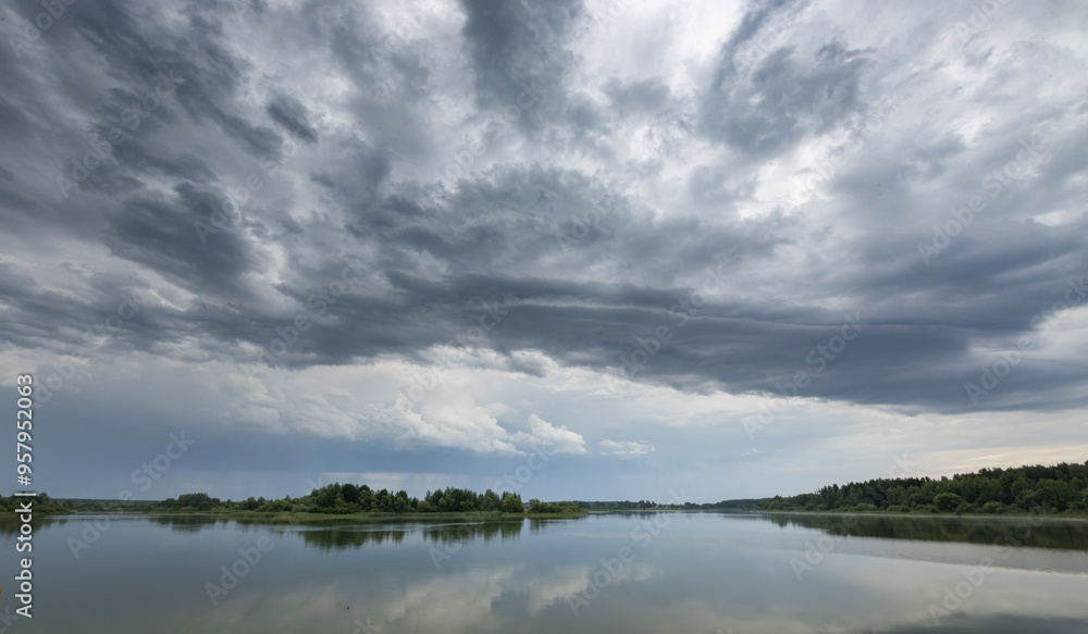A cloudy sky with a lake in the background A cloudy sky with a lake in the background