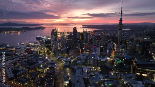 Dolly Flight through Auckland , New Zealand. Skyline. New Skyscrapers. Urban Canyon in Sunset or Sunrise Light. Aerial Pedestal in Establishing Night Drone Shot. Glowing street lights 