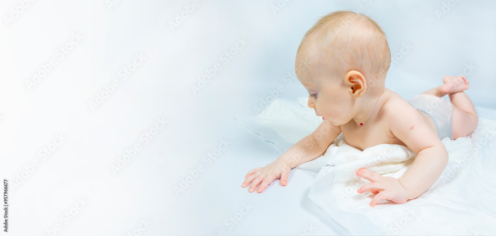 a baby with a hemangioma on his neck lies on a white background. banner with a copy space. profile of a little bald baby girl. the kid looks to the side