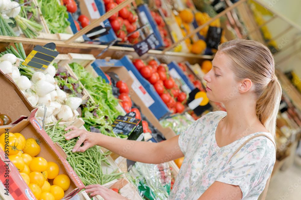 a woman is choosing the fresh vegetables a woman is choosing the fresh vegetables
