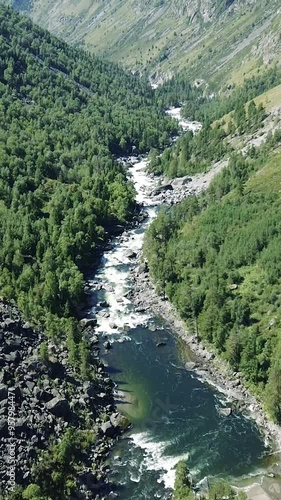 Mountain river with green trees. Aerial drone view. Abstract summer nature background. photo