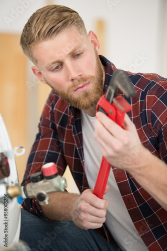 plumber man with tools in the kitchen photo