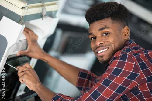 repairman working on a printer photo