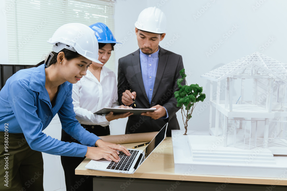 A team of architects and engineers work together in brainstorming sessions, discussing blueprints and construction plans for a real estate development. A team of architects and engineers work together in brainstorming sessions, discussing blueprints and construction plans for a real estate development.