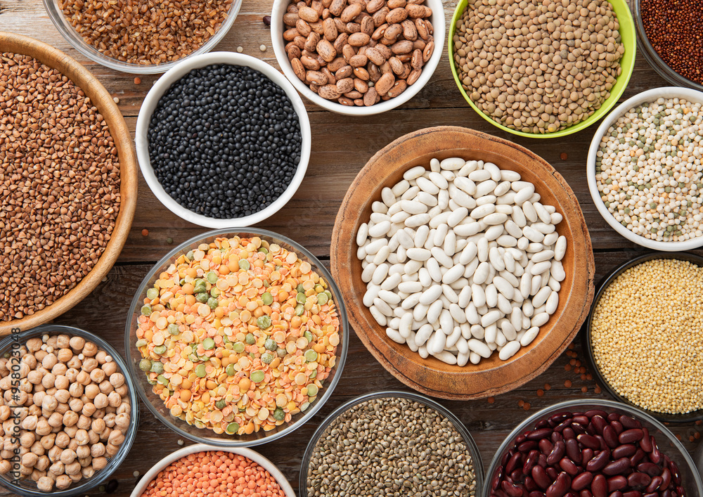 Bulgur,beans,quinoa,pea,couscous and hemp with chickpea and buckwheat seeds in various bowl plates on wooden kitchen background.Macro. Bulgur,beans,quinoa,pea,couscous and hemp with chickpea and buckwheat seeds in various bowl plates on wooden kitchen background.Macro.