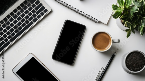 Aerial view of a modern workspace with smartphone, laptop, coffee cup, and plants during daylight hours