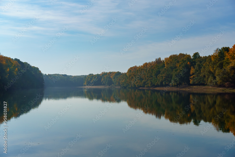 Obraz premium beautiful autumn landscape with river and forest, cloudy sky
