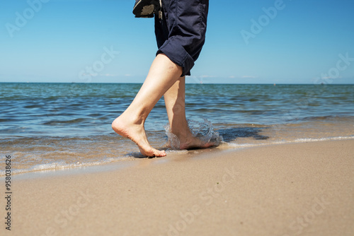 Woman walks along the seashore with blurred areas