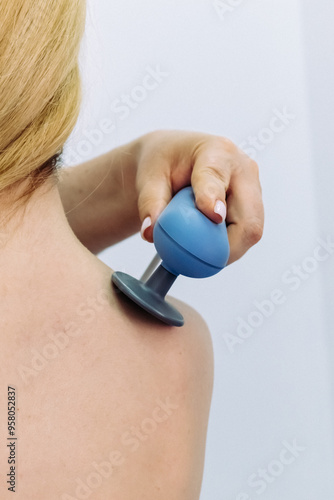 A doctor administers magnetic therapy to a young woman, targeting muscle recovery post-injury. Ideal for showcasing advanced physiotherapy treatments that accelerate healing and restore function.