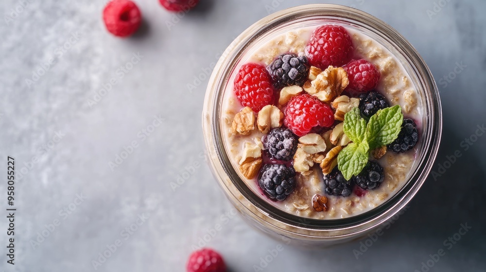 A jar of overnight oats topped with fresh berries, nuts, and honey, offering a nutritious and convenient breakfast option. Plenty of space for copy or promotional content. A jar of overnight oats topped with fresh berries, nuts, and honey, offering a nutritious and convenient breakfast option. Plenty of space for copy or promotional content.
