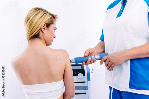 A physical therapist performs shock wave therapy with magnetic field assistance for targeted rehabilitation. Perfect for showcasing modern pain relief and advanced recovery techniques. photo