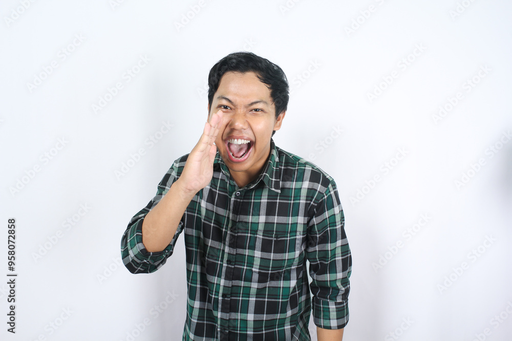 excited handsome attractive asian young man wearing green plaid shirt shouting to seek attention for hot news and discount announcement isolated excited handsome attractive asian young man wearing green plaid shirt shouting to seek attention for hot news and discount announcement isolated
