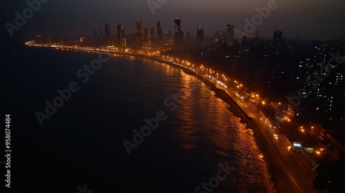 Aerial shot of Mumbai's Marine Drive, the 'Queen's Necklace' shimmering with city lights along the coastline. No people.