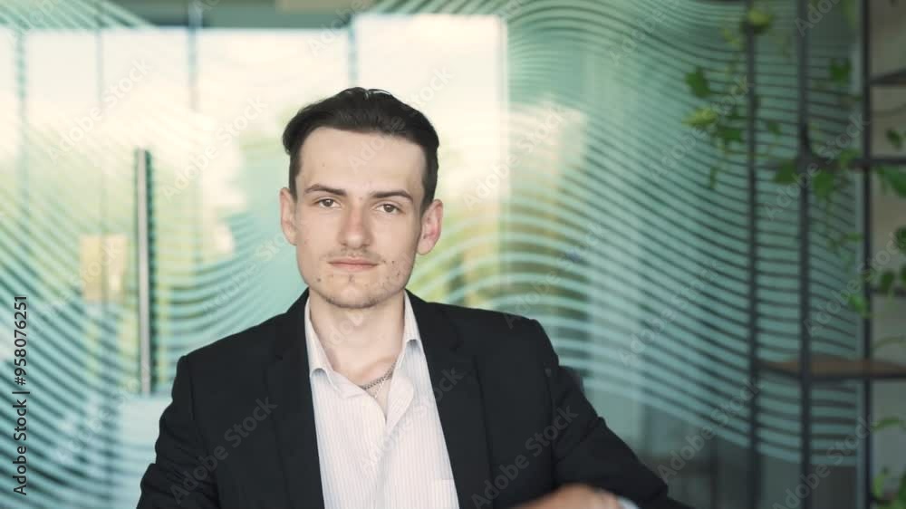 close-up portrait of a handsome, young, stylish man in business attire, sitting at a desk with a laptop in a modern office close-up portrait of a handsome, young, stylish man in business attire, sitting at a desk with a laptop in a modern office