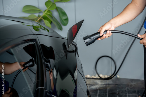 Electric vehicle users charge their electric vehicle batteries.