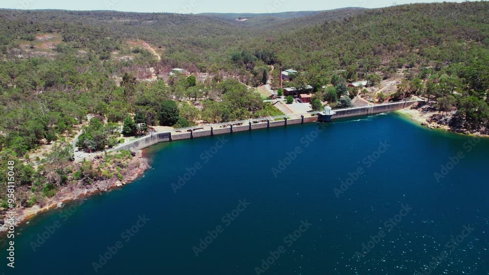 The serene reservoir, bordered by lush greenery, captures the bright sunlight, reflecting shades of blue and inviting exploration in a peaceful natural setting. The serene reservoir, bordered by lush greenery, captures the bright sunlight, reflecting shades of blue and inviting exploration in a peaceful natural setting.