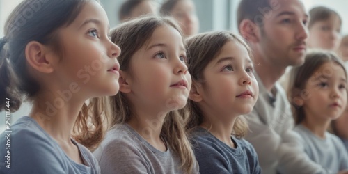 Curious diverse group of children and adults in classroom lookin