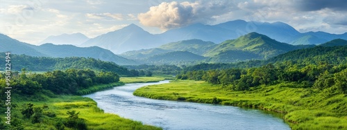  A river runs through a verdant valley, enclosed by lush green grass and distant mountains, topped with clouds in the sky