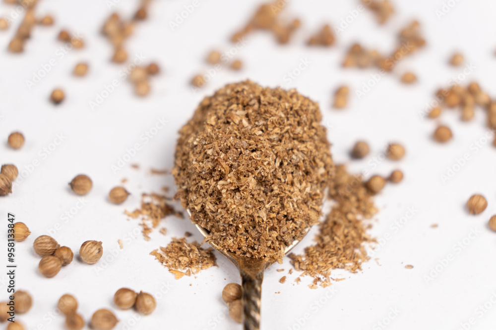 Ground coriander natural spice in a spoon close-up. Ground coriander natural spice in a spoon close-up.