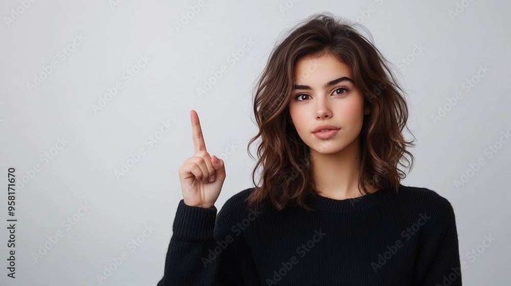 Woman presents, pointing finger up with copy space on light background, portrait beauty and confidence Woman presents, pointing finger up with copy space on light background, portrait beauty and confidence