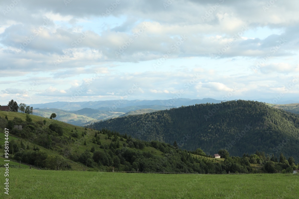 Picturesque view of beautiful mountains under cloudy sky Picturesque view of beautiful mountains under cloudy sky