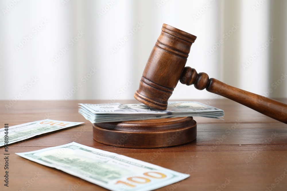 Alimony. Money, judge's gavel and sound block on wooden table, closeup Alimony. Money, judge's gavel and sound block on wooden table, closeup