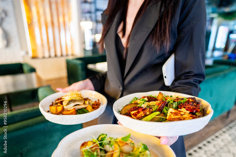 person holding three plates of food, showcasing a variety of dishes in a restaurant setting. Ideal for themes related to dining, hospitality, and culinary experiences. Bright and inviting atmosphere. person holding three plates of food, showcasing a variety of dishes in a restaurant setting. Ideal for themes related to dining, hospitality, and culinary experiences. Bright and inviting atmosphere.