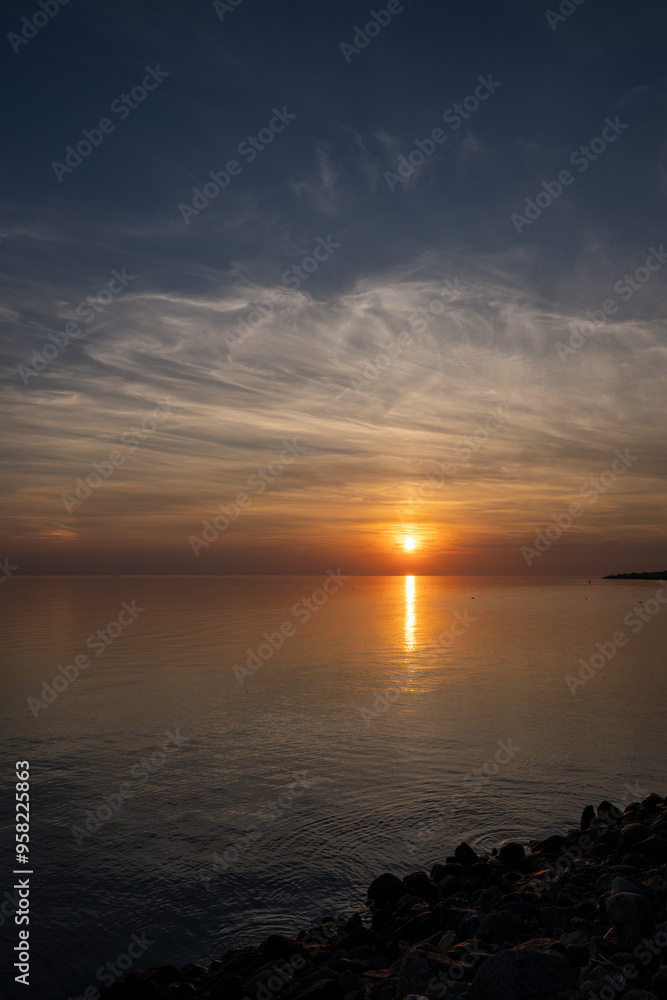 Obraz premium Die Nordsee bei Büsum - dramatisch schöner Sonnenuntergang mit Spiegelung auf dem Wasser und dem Watt