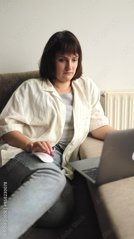 Business woman works remotely from a computer, laptop, remote work, online, work from home, technology, typing on a keyboard, searching in the Internet, girl sitting on the couch, comfort, freelancer Business woman works remotely from a computer, laptop, remote work, online, work from home, technology, typing on a keyboard, searching in the Internet, girl sitting on the couch, comfort, freelancer