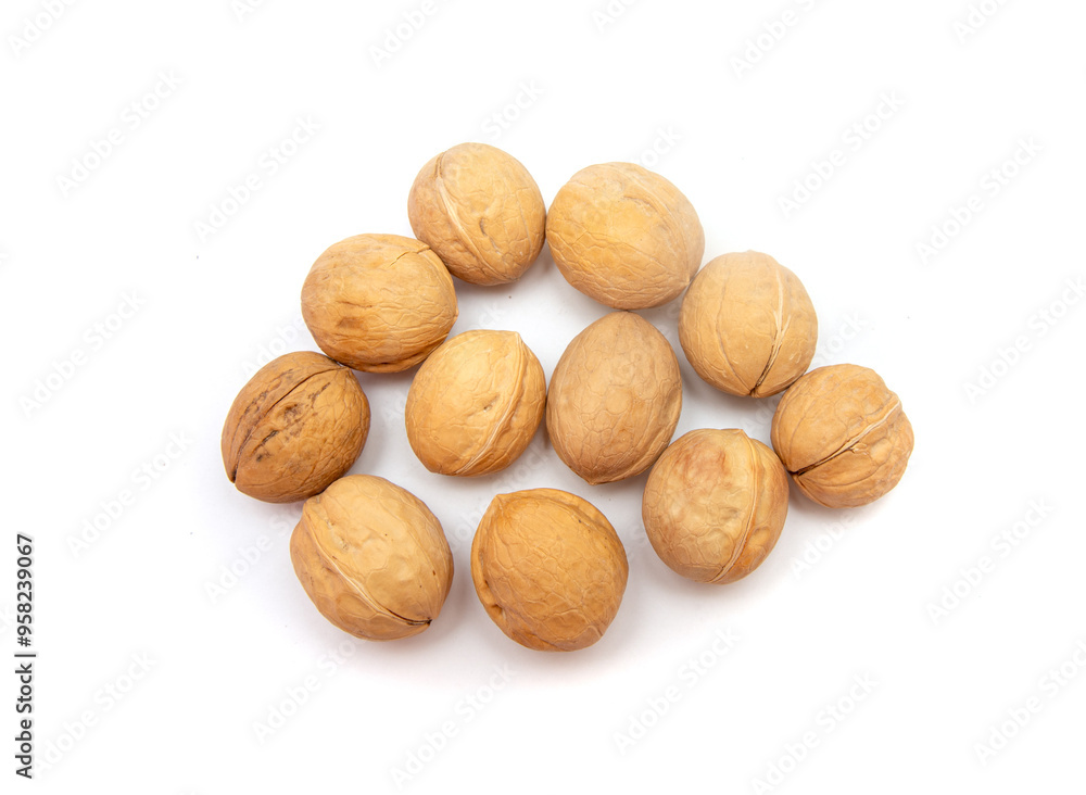A bunch of nuts are spread out on a white background A bunch of nuts are spread out on a white background