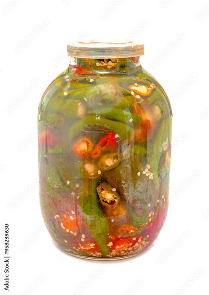 A jar of pickles with green peppers and red peppers A jar of pickles with green peppers and red peppers