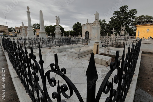 Group of marble sculptures atop sumptuous graves on the Avenida Cristobal Colon Avenue west side, Cementerio de Colon Cemetery. Havana-Cuba-086 photo