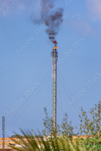 Fire from a gas torch in a large oil industry refinery factory in Skikda City, Algeria. photo