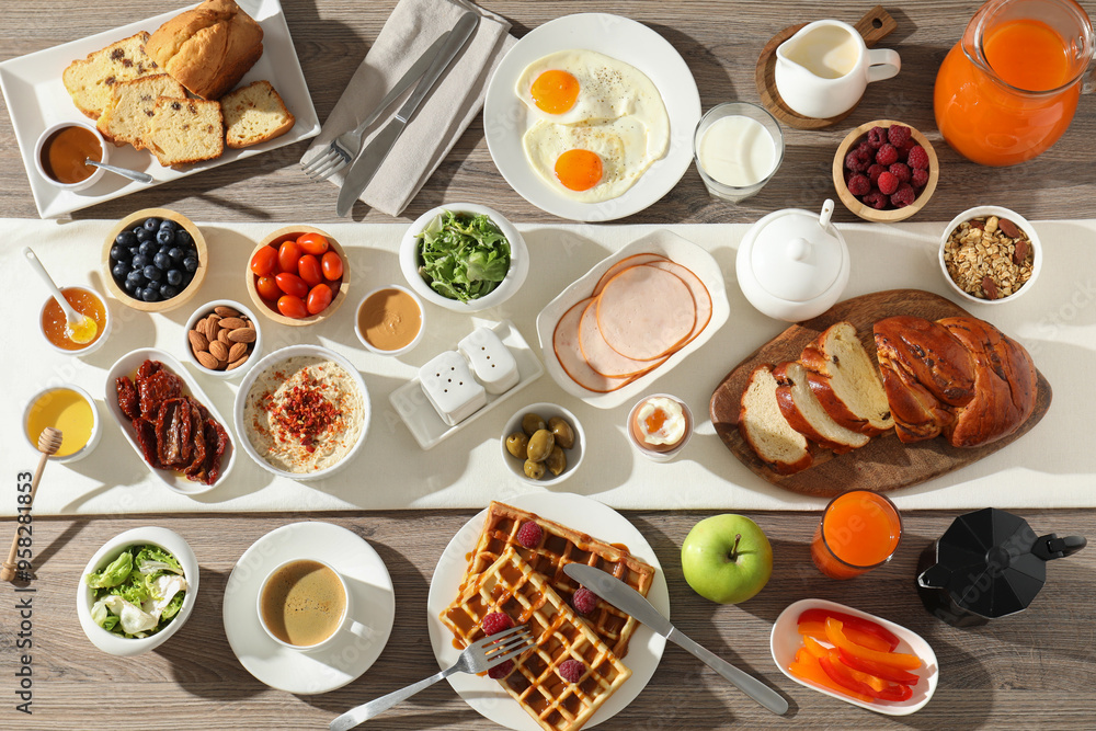 Different meals served for breakfast on wooden table, flat lay Different meals served for breakfast on wooden table, flat lay