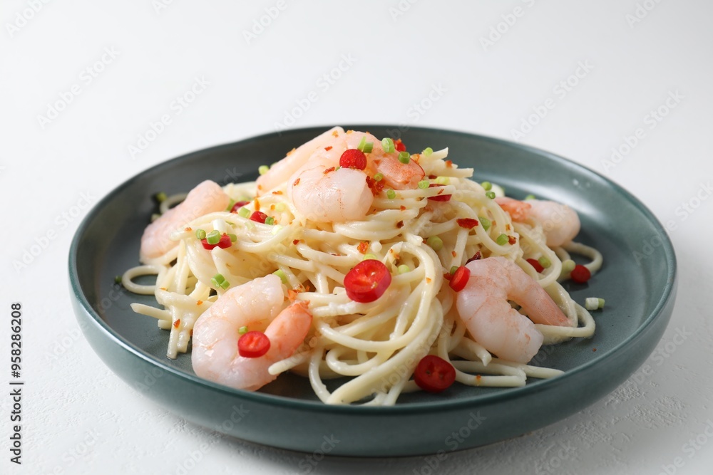 Delicious pasta with shrimps, green onion and chili pepper on white table, closeup Delicious pasta with shrimps, green onion and chili pepper on white table, closeup