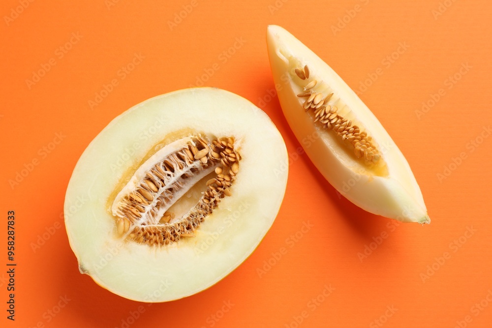 Fresh cut melon on orange background, flat lay Fresh cut melon on orange background, flat lay