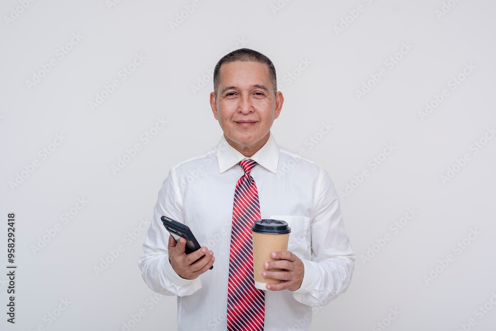 Friendly middle aged office male professional holding a phone and a cup of coffee. Set against a white background. Friendly middle aged office male professional holding a phone and a cup of coffee. Set against a white background.
