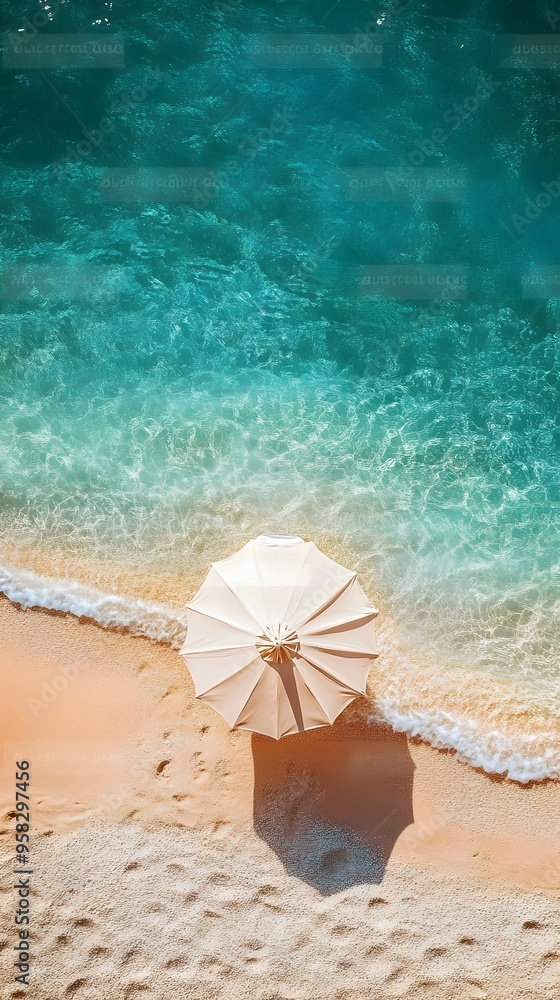 Naklejka premium Serene Beachside Solitude Aerial View of Solitary Sun Umbrella on Tranquil Sandy Shore