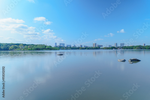 City park lake scenery with blue sky and white clouds