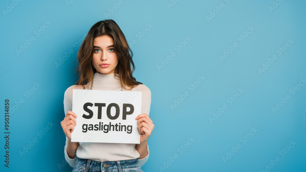 Young woman with Stop Gaslighting sign on blue background, banner with copy space for text. Concept of mental health and manipulation in abusive relationships with a narcissist partner or co-worker Young woman with Stop Gaslighting sign on blue background, banner with copy space for text. Concept of mental health and manipulation in abusive relationships with a narcissist partner or co-worker