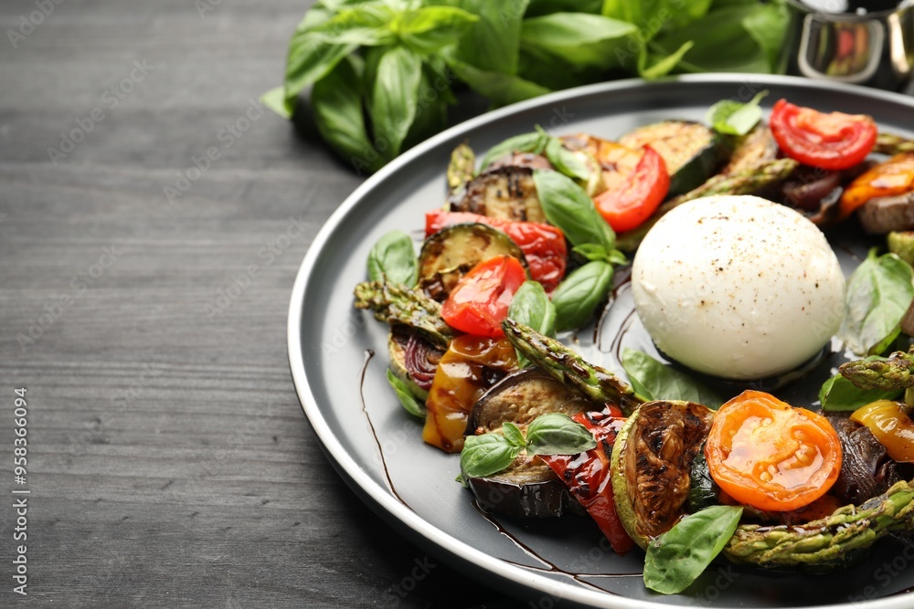 Tasty salad with grilled vegetables and mozzarella cheese on black table, closeup. Space for text Tasty salad with grilled vegetables and mozzarella cheese on black table, closeup. Space for text