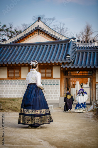 Tourists in national clothes walk in Gyeongbokgung Palace. Hanbok dress. South Korea 