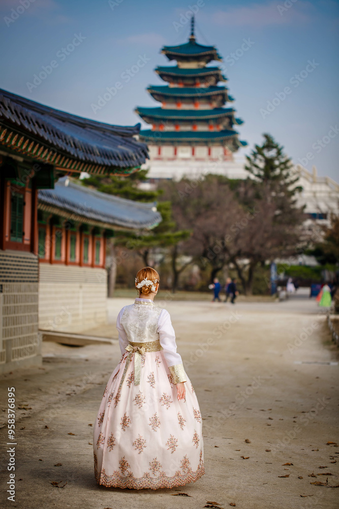 Tourists in national clothes walk in Gyeongbokgung Palace. Hanbok dress. South Korea