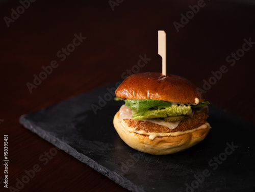 Chiken cheese burger with bacon on black background photo