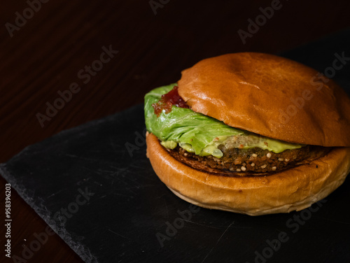 Cheese burger with bacon on black background photo