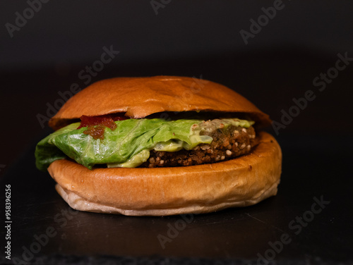 Cheese burger with bacon on black background photo