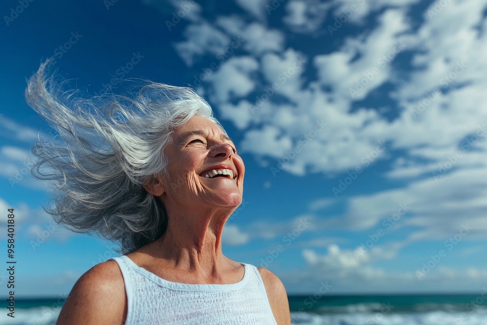 Joyful Woman with Silver Hair Enjoying the Breeze at the Beach with a Bright Sky in the Background Joyful Woman with Silver Hair Enjoying the Breeze at the Beach with a Bright Sky in the Background