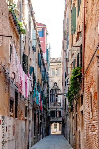 A stunningly picturesque alley in the heart of Venice, showcasing laundry hanging among beautiful historic buildings