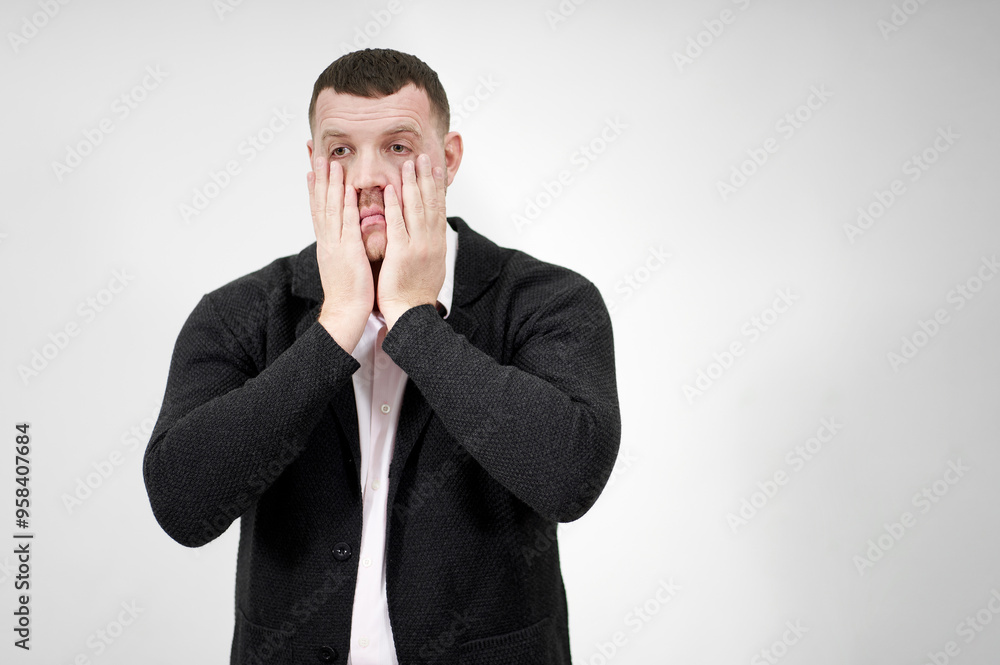 Stressed businessman with hands on the face over grey background with copy space, sadness and disappointed concept Stressed businessman with hands on the face over grey background with copy space, sadness and disappointed concept